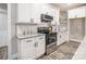 Modern kitchen with white cabinets, granite countertops, and stainless steel appliances at 2434 Wo Gladden Rd, Chester, SC 29706