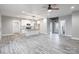 Open concept kitchen and living area with white cabinets and gray flooring at 2434 Wo Gladden Rd, Chester, SC 29706
