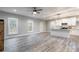 Open concept kitchen and living area with white cabinets and gray flooring at 2434 Wo Gladden Rd, Chester, SC 29706