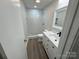 Modern bathroom with a white vanity, tiled shower, and stone flooring at 3225 Cricketeer Dr, Charlotte, NC 28216