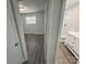 View of bedroom and bathroom with wood-look floors at 3225 Cricketeer Dr, Charlotte, NC 28216