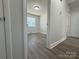 View of bedroom with wood-look floors and access to bathroom at 3225 Cricketeer Dr, Charlotte, NC 28216