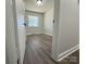Simple bedroom with hardwood floors and a window at 3225 Cricketeer Dr, Charlotte, NC 28216