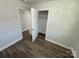 Bedroom with wood-look floors and closet at 3225 Cricketeer Dr, Charlotte, NC 28216