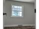 Well-lit bedroom with a large window and wood-look floors at 3225 Cricketeer Dr, Charlotte, NC 28216