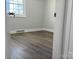 Bright bedroom with wood-look floors and a window at 3225 Cricketeer Dr, Charlotte, NC 28216