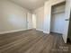 Bright bedroom with wood-look floors and closet at 3225 Cricketeer Dr, Charlotte, NC 28216