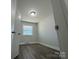 Spacious bedroom with wood-look floors and a window at 3225 Cricketeer Dr, Charlotte, NC 28216