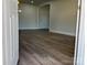 View from entry door showing dark wood-look flooring and interior doors at 3225 Cricketeer Dr, Charlotte, NC 28216