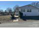 White brick side of house with walkway leading to the entrance at 3225 Cricketeer Dr, Charlotte, NC 28216