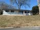 Newly renovated ranch home with a white brick exterior and covered porch at 3225 Cricketeer Dr, Charlotte, NC 28216