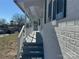 White brick exterior with a long covered porch and white railing at 3225 Cricketeer Dr, Charlotte, NC 28216