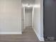 Bright hallway with light gray walls and wood-look flooring at 3225 Cricketeer Dr, Charlotte, NC 28216