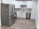 Modern kitchen with white shaker cabinets, stainless steel appliances, and gray backsplash at 3225 Cricketeer Dr, Charlotte, NC 28216