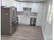 Renovated kitchen with stainless steel refrigerator and white shaker cabinets at 3225 Cricketeer Dr, Charlotte, NC 28216