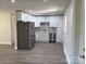 Modern kitchen with white shaker cabinets, stainless steel appliances, and gray backsplash at 3225 Cricketeer Dr, Charlotte, NC 28216