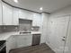 Updated kitchen with white cabinets, stainless steel dishwasher, and gray tile backsplash at 3225 Cricketeer Dr, Charlotte, NC 28216