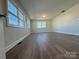 Spacious living area featuring neutral walls and wood-look flooring at 3225 Cricketeer Dr, Charlotte, NC 28216
