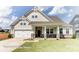 Two-story home with stone accents and a front porch at 4010 Cedar Falls Dr # 23, Waxhaw, NC 28173