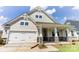 Two-story home with stone accents and a front porch at 4010 Cedar Falls Dr # 23, Waxhaw, NC 28173