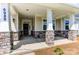 Covered front porch with stone columns and flooring at 4010 Cedar Falls Dr # 23, Waxhaw, NC 28173
