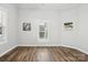 Well-lit bedroom with hardwood floors and neutral walls at 402 N Davis Ave, Newton, NC 28658