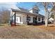 Two-story craftsman style home with a covered porch and mature trees at 402 N Davis Ave, Newton, NC 28658