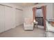 Bedroom with glider chair, dresser, and crib at 4930 Sardis Rd # D, Charlotte, NC 28270