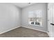 Bright bedroom with neutral carpet and a window with blinds at 5809 Avian Sw Pl, Concord, NC 28025