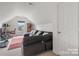 Spacious bonus room with sectional sofa and home office at 6107 Follow The Trl, Indian Trail, NC 28079