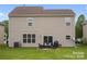 Tan house exterior with patio and grassy backyard at 6107 Follow The Trl, Indian Trail, NC 28079