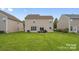 Tan house exterior with backyard and patio furniture at 6107 Follow The Trl, Indian Trail, NC 28079
