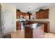 Kitchen with island, stainless steel appliances, and view to backyard at 6107 Follow The Trl, Indian Trail, NC 28079