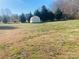 Large backyard with shed and trees at 623 Faith St, Oakboro, NC 28129