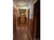 Long hallway with wood paneling and wood-look flooring at 708 2Nd Nw Ave, Conover, NC 28613