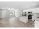 Modern kitchen with white cabinets, granite counters, and stainless steel appliances at 801 S Long St, Salisbury, NC 28144