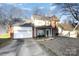 Two-story brick home with attached garage and landscaped yard at 1009 Stinson Glen Ln, Charlotte, NC 28214