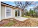Tan house with sliding glass door leading to a small patio at 11015 Vista Haven Dr, Charlotte, NC 28226
