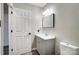 Neat bathroom with gray vanity and toilet at 11015 Vista Haven Dr, Charlotte, NC 28226