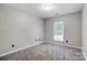 Bright bedroom with gray carpeting and a window at 11015 Vista Haven Dr, Charlotte, NC 28226