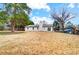 Back of house with a sliding glass door and chimney, overlooking yard at 11015 Vista Haven Dr, Charlotte, NC 28226