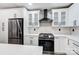 Modern kitchen with stainless steel appliances and white cabinets at 11015 Vista Haven Dr, Charlotte, NC 28226