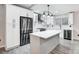 Modern kitchen with white cabinets, island, and stainless steel appliances at 11015 Vista Haven Dr, Charlotte, NC 28226