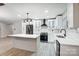 Modern kitchen with white cabinets, stainless steel appliances, and an island at 11015 Vista Haven Dr, Charlotte, NC 28226