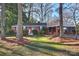 Brick ranch home with carport, mature trees, and a well-manicured lawn at 1108 Sewickley Dr, Charlotte, NC 28209