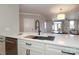 Modern kitchen island with quartz countertop and stainless steel sink at 1129 Park West Dr, Charlotte, NC 28209