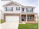 Two-story house with stone accents and a two-car garage at 130 Paige Rd # 12, Kings Mountain, NC 28086