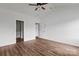 Bedroom with neutral color palette and a ceiling fan; closet and additional room access at 143 Tranquility Ln, Harmony, NC 28634