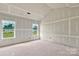 A bright bedroom featuring a large window overlooking the lawn, ready for your design at 143 Tranquility Ln, Harmony, NC 28634