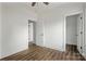 Open bedroom featuring wood look LVP flooring and doorways leading to other areas of the house at 143 Tranquility Ln, Harmony, NC 28634